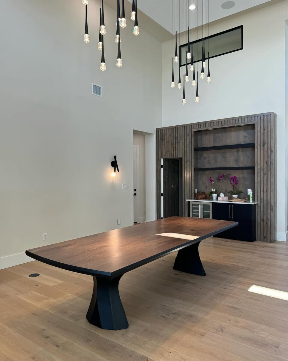 Walnut dining table with a black steel base in a modern San Antonio home